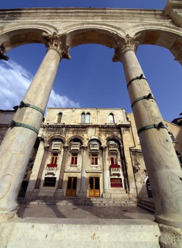 a building with two large columns in front of it at Holiday Home Aspalathos - with free parking, near the beach, a few minutes' walking distance to the UNESCO Palace in Split