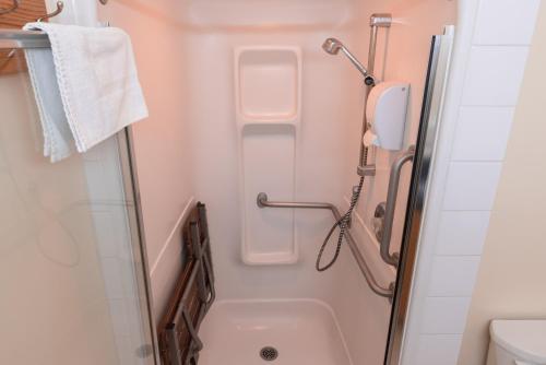 a small bathroom with a shower and a toilet at HI Banff Alpine Centre - Hostel in Banff
