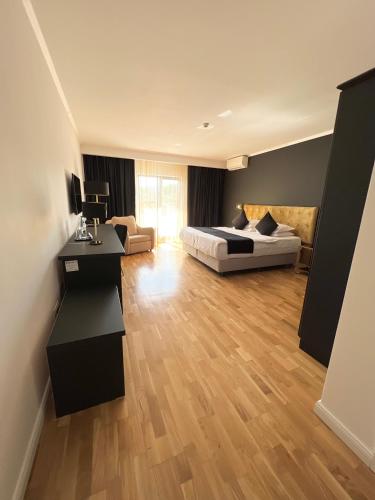 a bedroom with a bed and a living room at Krystal Boutique Mansion in Hunedoara