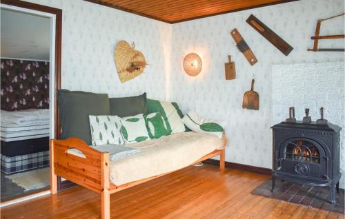 a room with a bed and a wood stove at Pet Friendly Home In Backaryd With House A Panoramic View in Backaryd