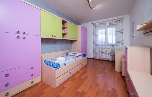 a childs bedroom with a bed and cabinets at Cozy Home In Nedescina With Kitchen in Nedeščina