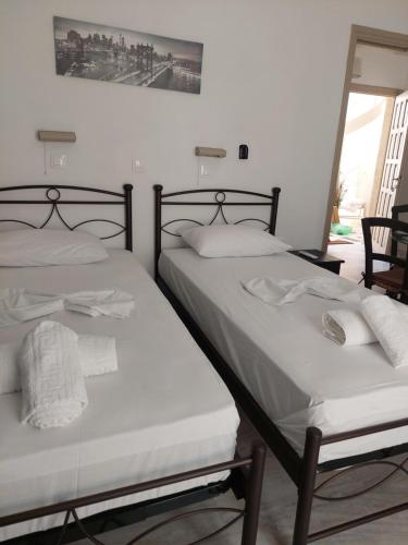 two beds sitting next to each other in a room at Studio Tsakas in Naxos Chora