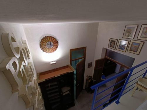 a room with a staircase and a mirror on the wall at Syd's House in Bagheria