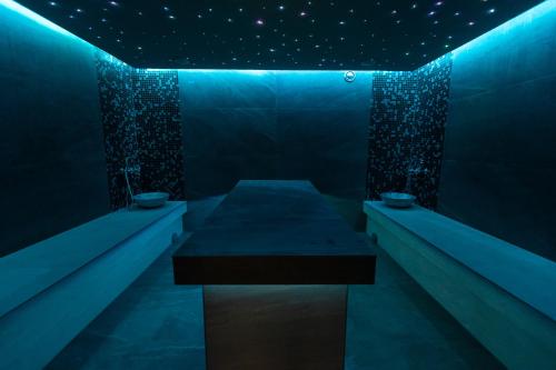 a blue room with a table in the middle at Panorama Górska Wisła Resort & SPA in Wisła
