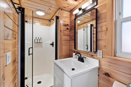 a bathroom with a sink and a shower at Wolfjaw Lodge in Wilmington