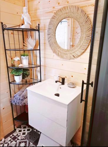 a bathroom with a white sink and a mirror at Dreamholia in Jastarnia