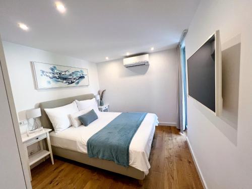 a bedroom with a large bed in a room at VILLA ONEUM - Apartment MARE with privat JACUZZI in Omiš