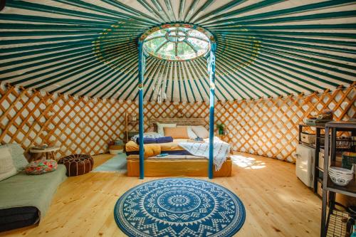 a room with a tent with a bed in it at Yurt in the Wood 