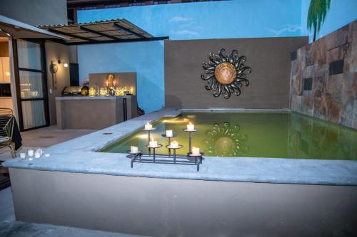 a jacuzzi tub in a room with candles in it at Casa Lana Central in Ajijic