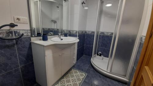 a bathroom with a sink and a shower at ZUBEROA- vistas, terraza y parking in Zarautz