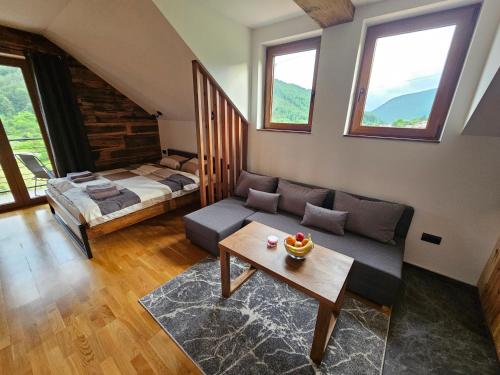 a living room with a couch and a bed at Apartment 112 in Mokra Gora