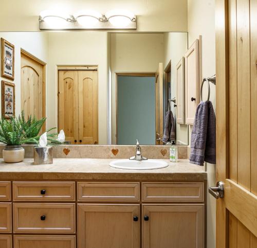 a bathroom with a sink and a large mirror at Palatial Paradise with Breathtaking Views of Red Rock and Stunning Infinity Pool in Sedona