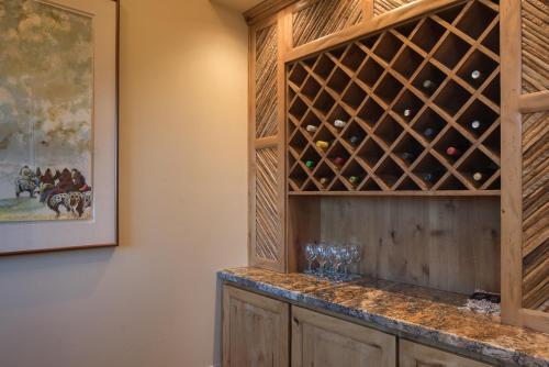 a wine cellar with wine glasses on a counter at Palatial Paradise with Breathtaking Views of Red Rock and Stunning Infinity Pool in Sedona