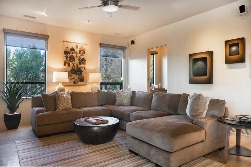 a living room with a couch and a table at Palatial Paradise with Breathtaking Views of Red Rock and Stunning Infinity Pool in Sedona