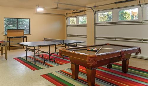 a room with two ping pong tables on a rug at Palatial Paradise with Breathtaking Views of Red Rock and Stunning Infinity Pool in Sedona
