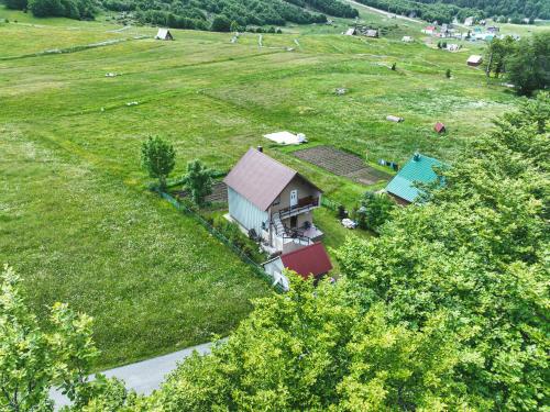 an aerial view of a house in the middle of a field at Guest House "Višnja" in Žabljak