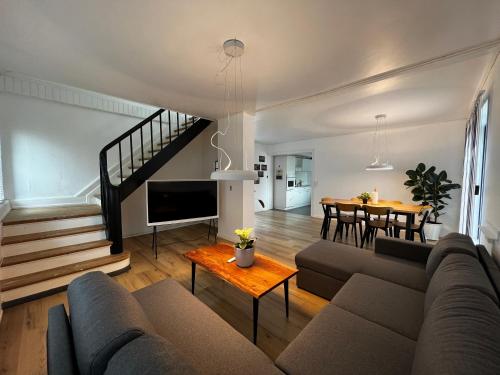 a living room with a couch and a table at Cozy Holeby House Close to Puttgarden & Femern & Lalandia & Knuthenborg in Holeby