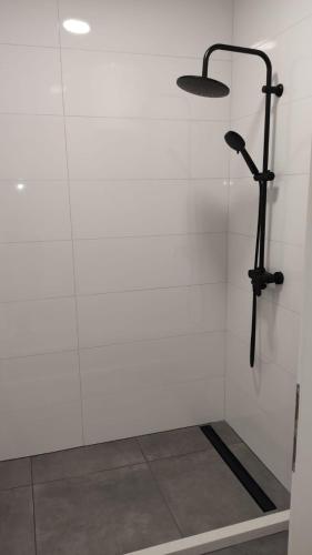 a shower in a room with a white wall at New Ursic App 4+2 in Brela