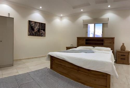 a bedroom with a large bed with white sheets at 2 Bedrooms Apartment in Makkah in Mecca