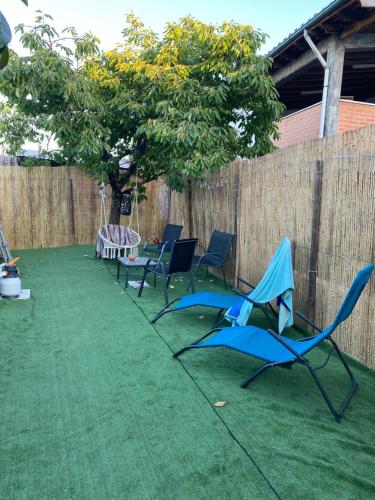 a patio with chairs and a table and a fence at Casa Gorjão in Anadia