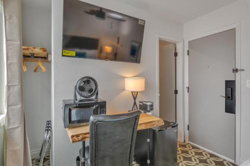 a room with a desk with a computer and a chair at Highliner Hotel - Queen Suites in Anchorage
