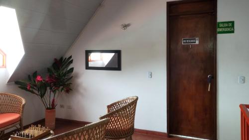 a room with a table and chairs and a door at Finca Turistica Rural El Descanso, privada Restrepo, Meta - Colombia in Restrepo