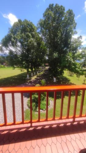 an orange fence with trees in a park at Finca Turistica Rural El Descanso, privada Restrepo, Meta - Colombia in Restrepo