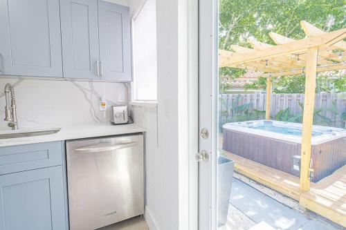 a kitchen with a view of a hot tub at HOUSE WITH A HOT TUB ! ONLY 10 MINS TO THE BEACH in Biscayne Park