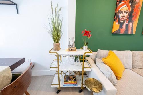 a living room with a couch and a table at HOUSE WITH A HOT TUB ! ONLY 10 MINS TO THE BEACH in Biscayne Park