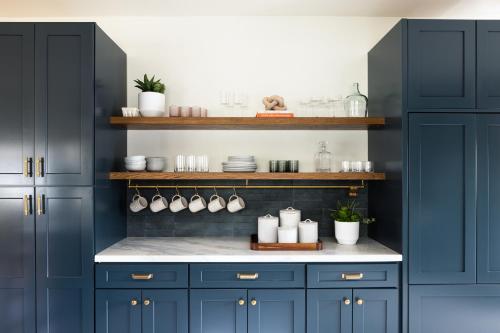a kitchen with blue cabinets and a white counter top at The Richland in Orange