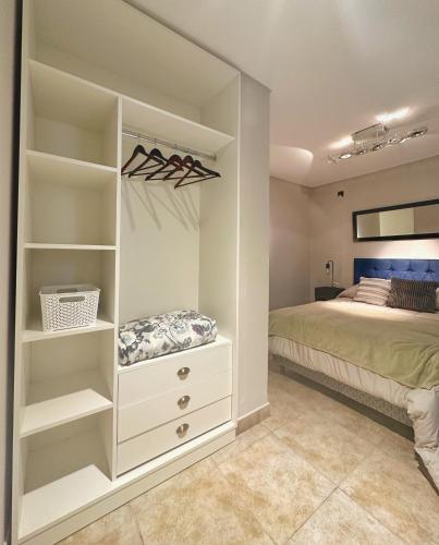 a bedroom with a bed and a white closet at Paramont Rosario 1 in Rosario de la Frontera