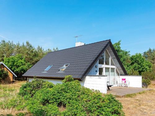 uma casa com um telhado preto com um deque em 8 person holiday home in Fur em Fur
