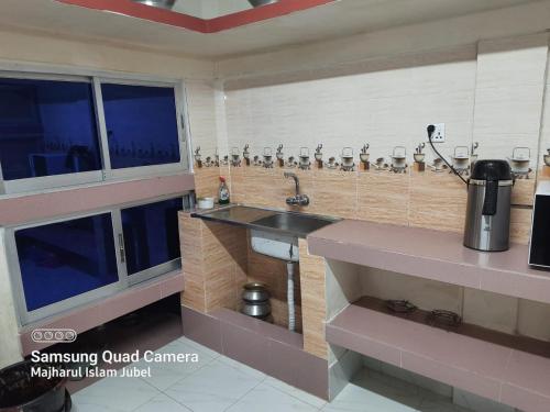 a kitchen with a sink and a counter at Sunapur Mini Resort Sylhet in Sylhet