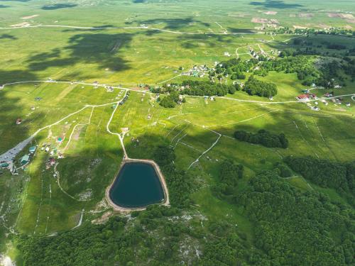 an aerial view of a park with a large field at Guest House "Višnja" in Žabljak