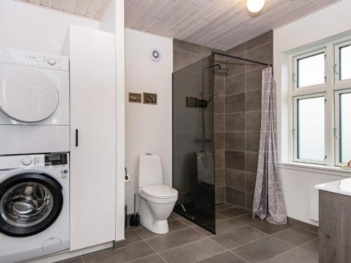 a bathroom with a toilet and a shower and a sink at Holiday home Bjert XXII in Binderup Strand