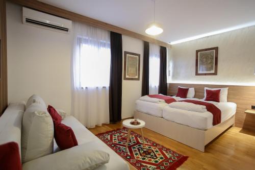 a living room with two beds and a couch at Hotel Emen in Mostar