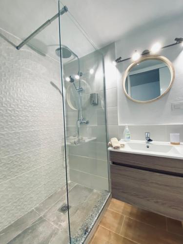a bathroom with a glass shower and a sink at Casa Gercko 1 in Yaiza