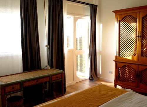 a bedroom with a bed and a window and a door at The Hay Shed in Mitchells Island