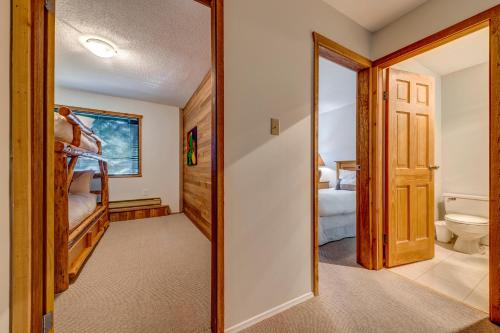 a bedroom with a bunk bed and a bathroom at Telemark 8 in Whistler