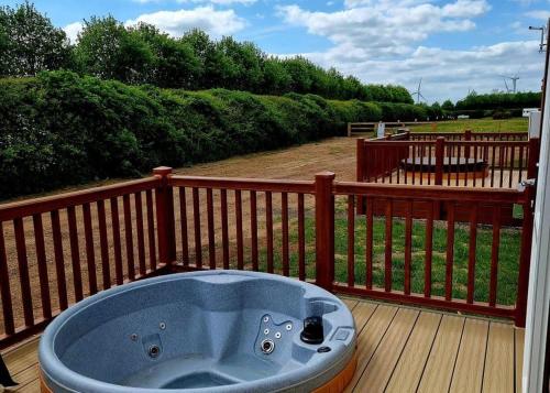a jacuzzi tub sitting on a deck at High Farm Holiday Park in Beverley