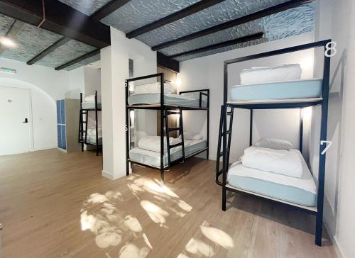 a room with three bunk beds in it at A TROITA HOSTeL in Tui