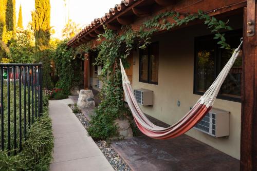 a hammock hanging from the side of a house at Los Arboles Hotel in Palm Springs