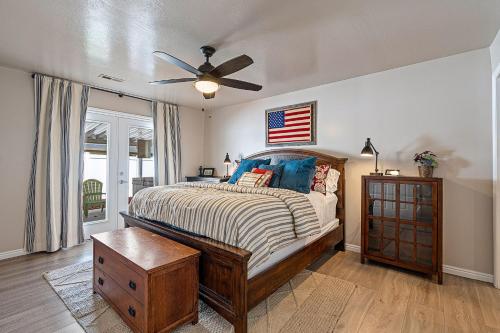 a bedroom with a bed and a ceiling fan at Fully Stocked Home with Hot Tub and Private Yard in Ogden