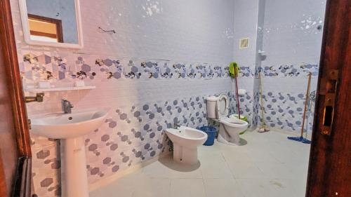 a bathroom with two toilets and a sink at Oued Laou Apartment in Oued Laou