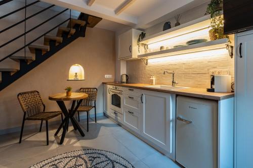 a kitchen with a sink and a table with chairs at Mosaic Luxury Home in Rhodes Town