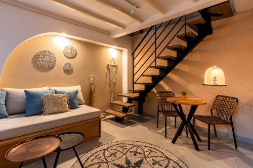a room with a bed and a staircase and a table at Mosaic Luxury Home in Rhodes Town