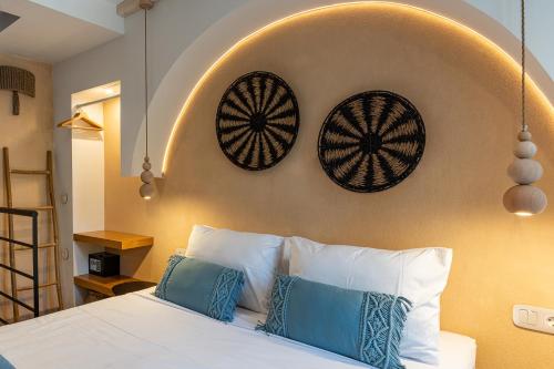 a bedroom with a white bed with two pillows at Mosaic Luxury Home in Rhodes Town
