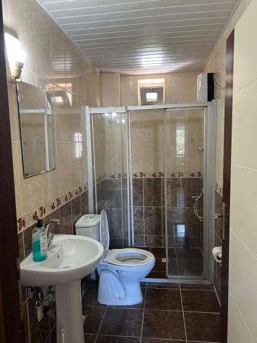 a bathroom with a toilet and a shower and a sink at Şehrin Kalbinde Denize Yakın in Antalya