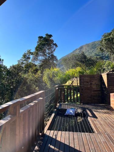 a wooden deck with a view of a mountain at Recanto das Cachoeiras in Angelina
