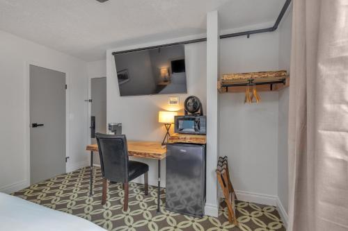 a small room with a desk and a microwave at Highliner Hotel- King Suite 312 with City View Hotel Room in Anchorage